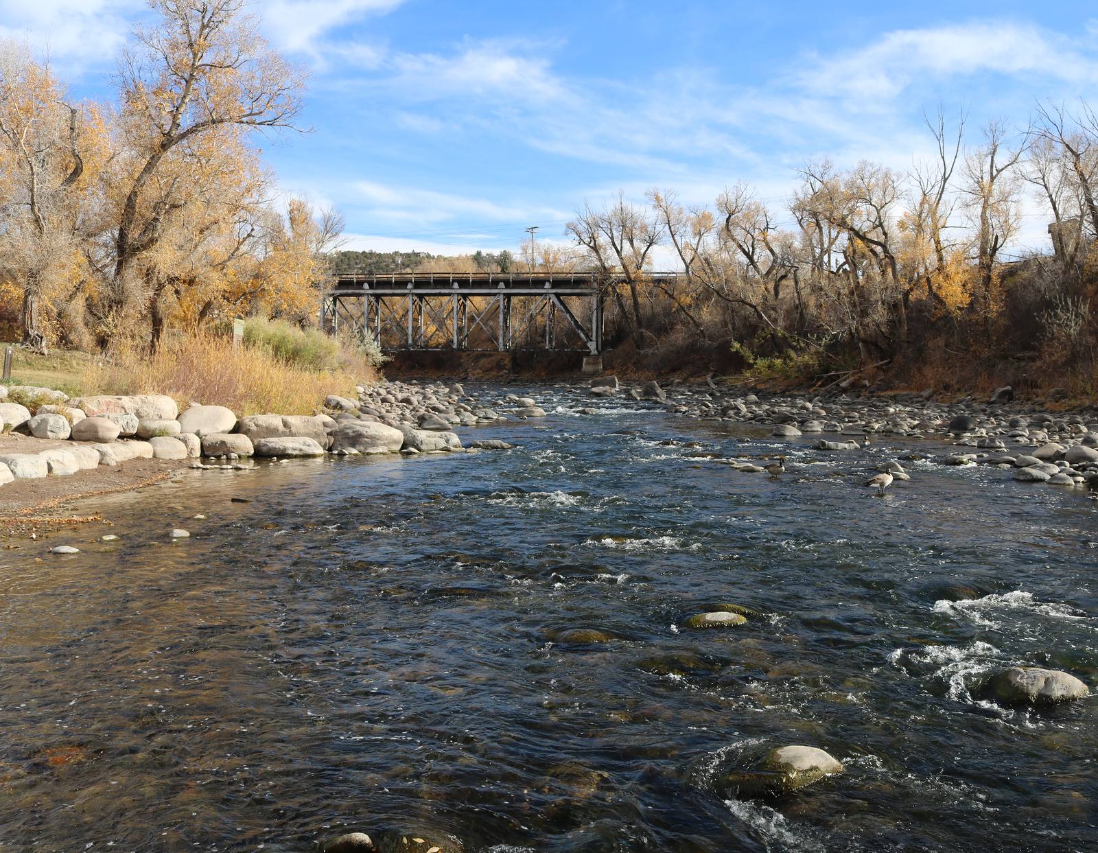 The Eagle River passing through Chambers Park in the town of Eagle, below a railroad bridge, in a file photograph. Eagle is the Eagle County seat, and the river corridor runs through the landscape the county's three conservation plans are meant to cover.