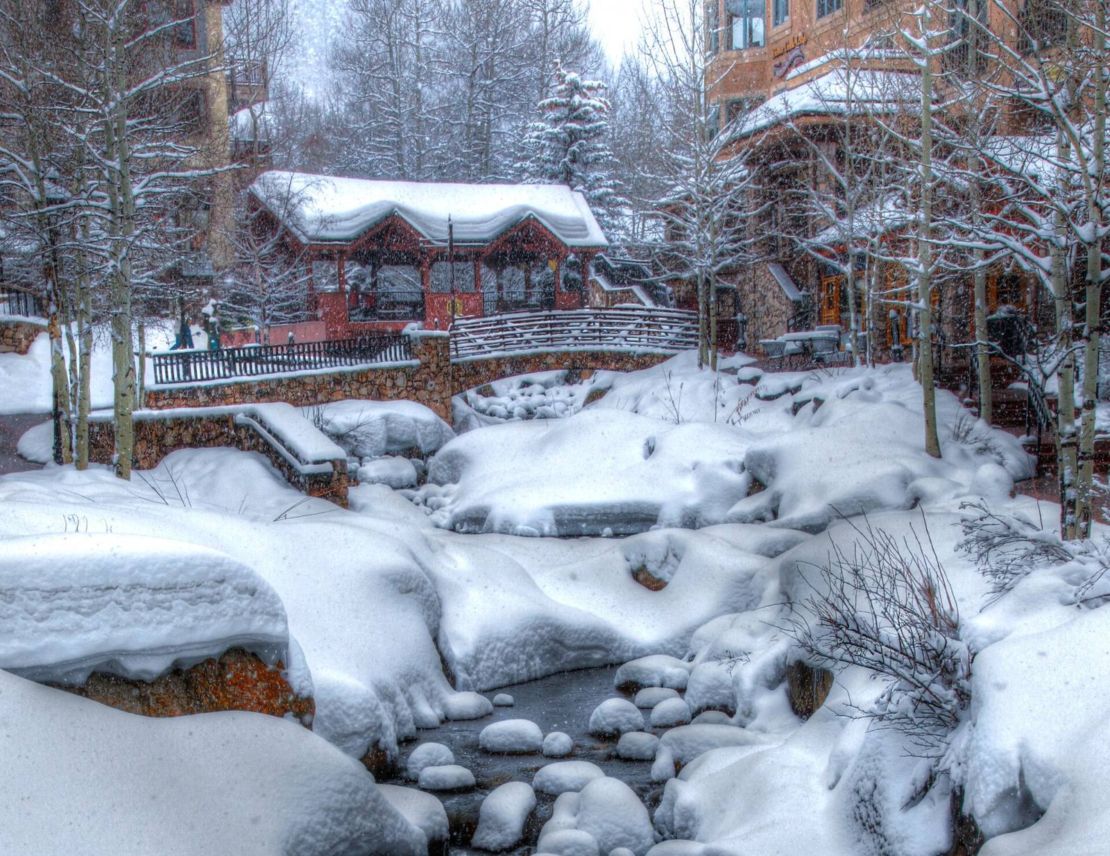 Snow blankets the creek and footbridge in Beaver Creek Village in a file photograph from an earlier winter. Beaver Creek's first snow of this season arrived overnight this week, ahead of a planned Nov. 25 opening.