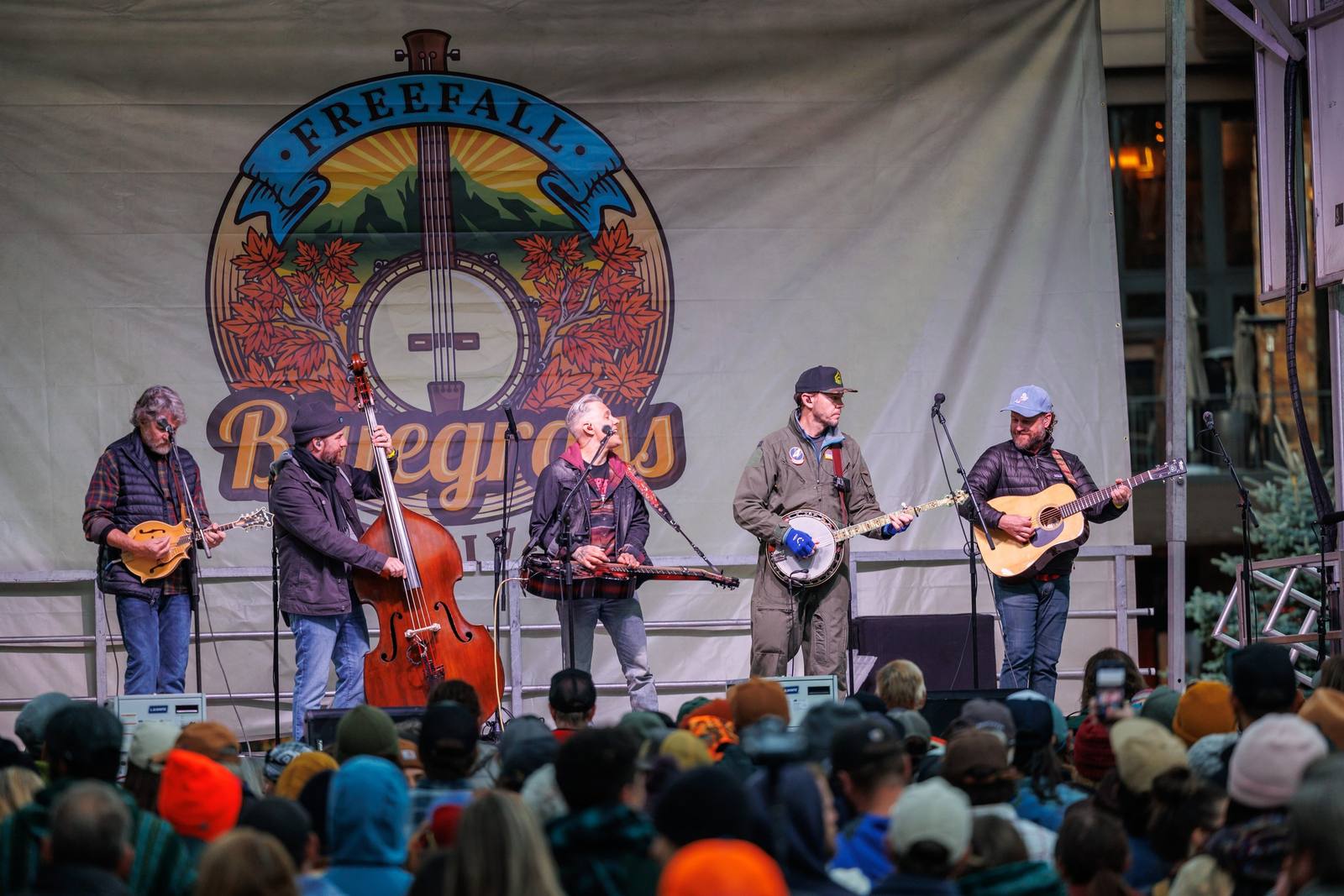 Musicians perform in front of the FreeFall Bluegrass Festival banner. Sunday's closing day is headlined by Molly Tuttle, with Nicki Bluhm also on the bill.