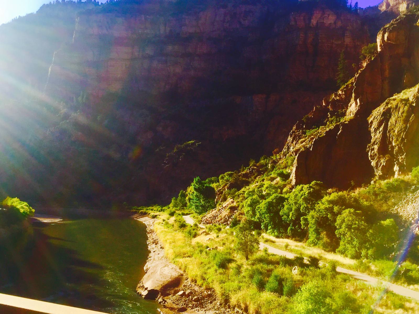 The Colorado River and the canyon recreation path below the cliffs in Glenwood Canyon, in a file photograph. Phase 8 also includes clearing remaining fire and flood debris from the river, CDOT said.