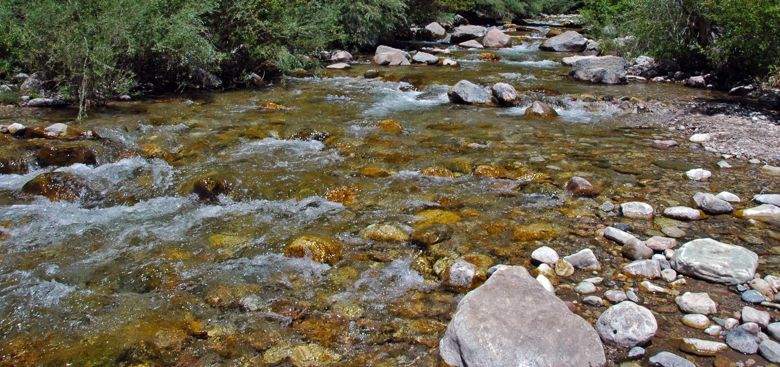 Grizzly Creek runs clear over rock in Glenwood Canyon, in a file photograph. The 2021 Grizzly Creek Fire and later floods left debris that Phase 8 crews will clear, with new barriers built above the Hanging Lake Tunnels.