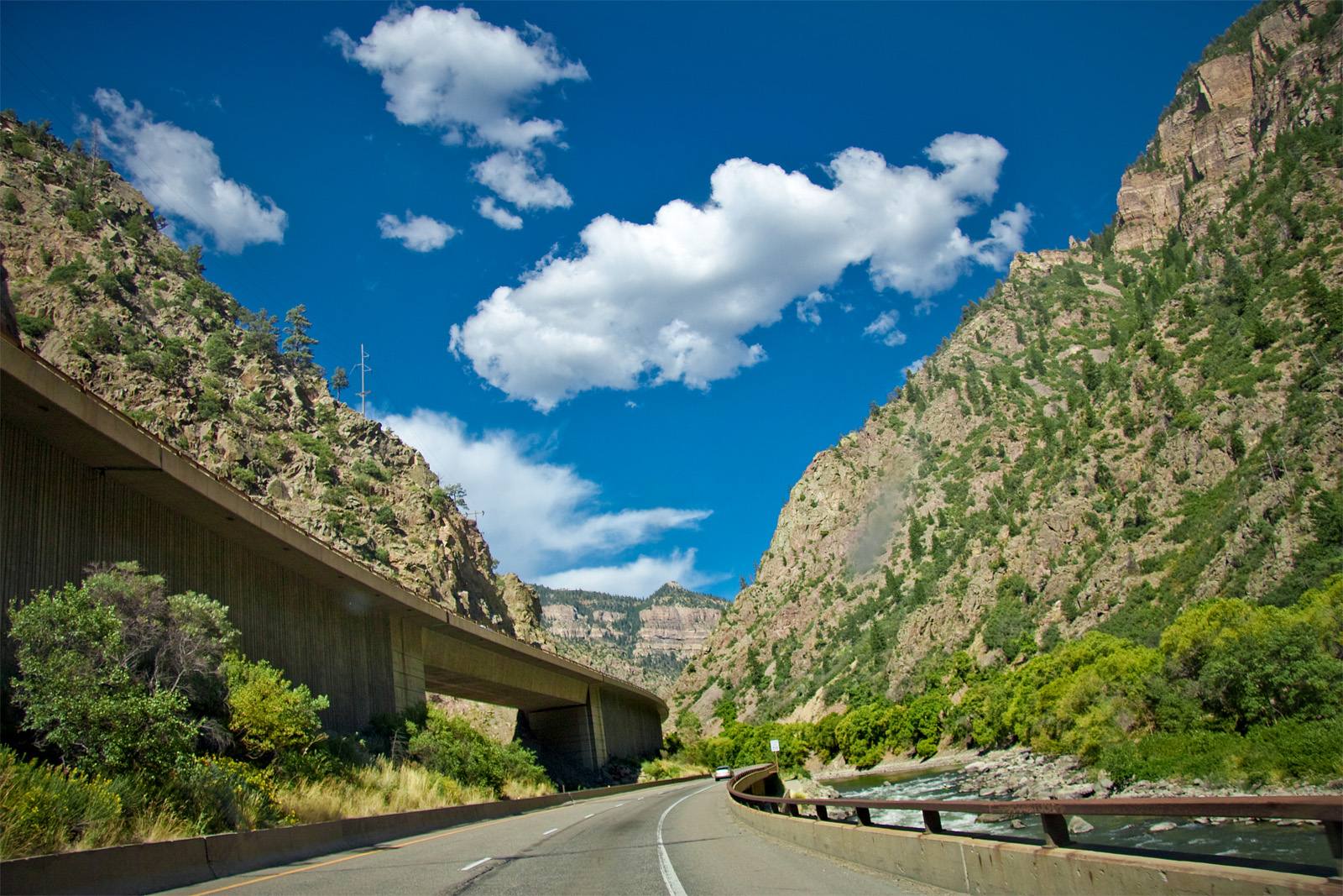 Interstate 70 runs on elevated viaducts through Glenwood Canyon beside the Colorado River, in a file photograph. Phase 8 will resurface lanes and tunnel interiors along 16.5 miles of this corridor, now starting in 2028 instead of 2027.