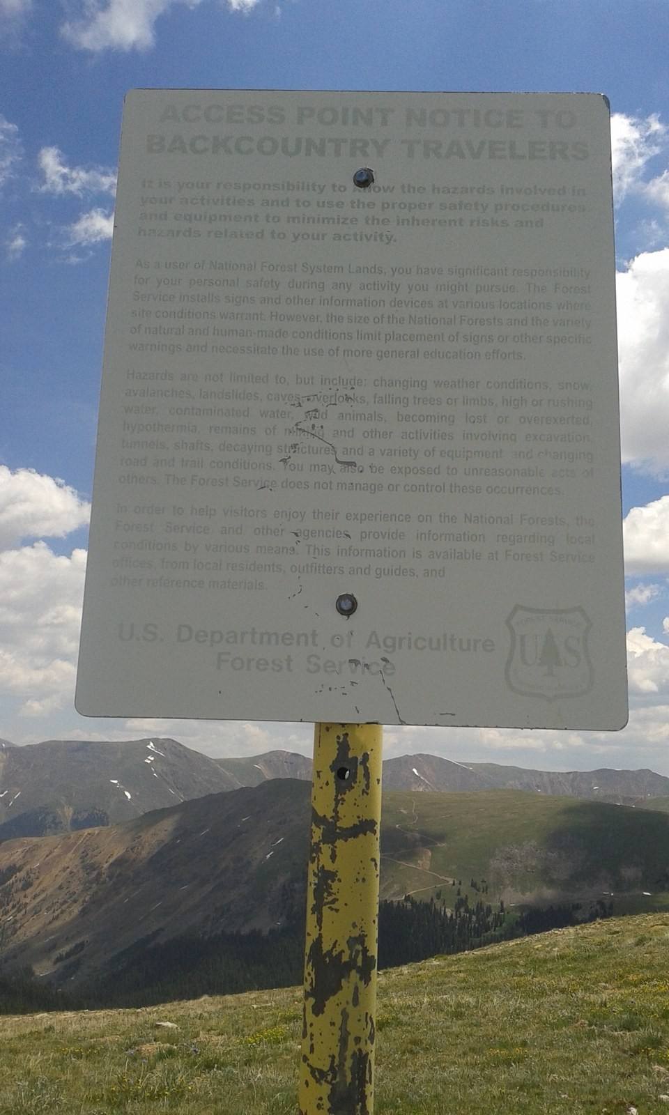 A U.S. Forest Service notice to backcountry travelers at a mountain trailhead.