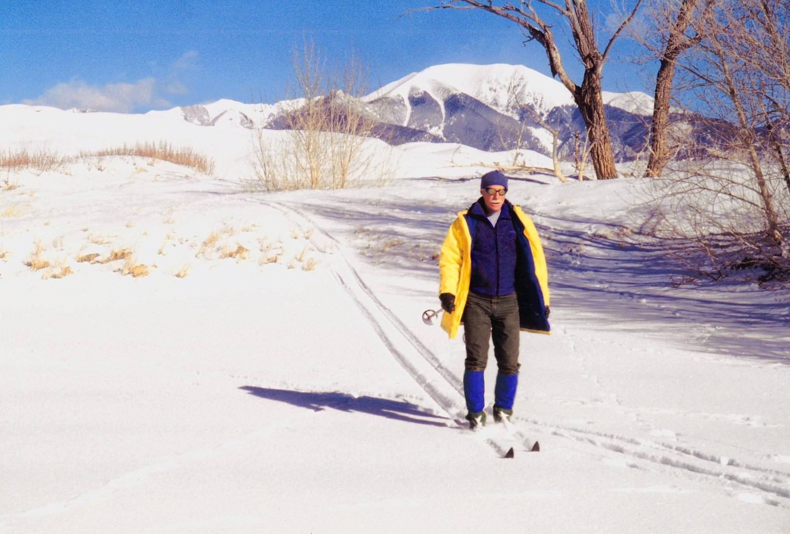 A skier touring on snow in Colorado's high country. Illustrative photo; the CAIC forecast applies to backcountry travel in avalanche terrain.