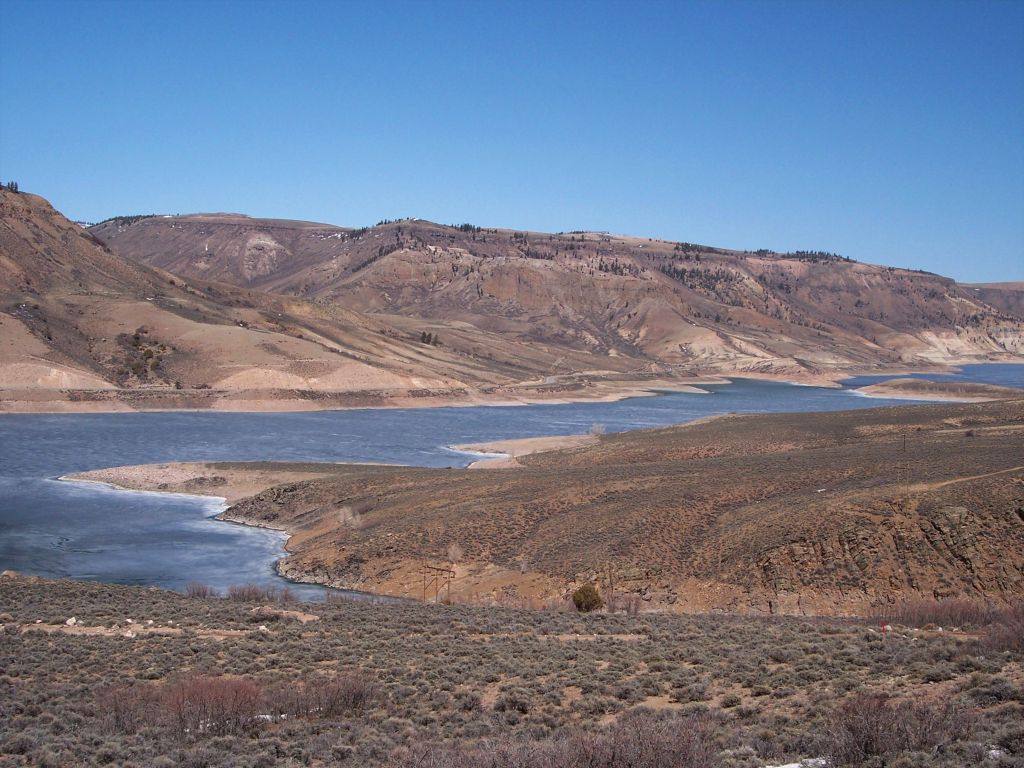 Blue Mesa Reservoir on the Gunnison River, in a file photograph. The novel's fictional Iola is drawn from the real Gunnison River community that disappeared when the reservoir was created in the 1960s.