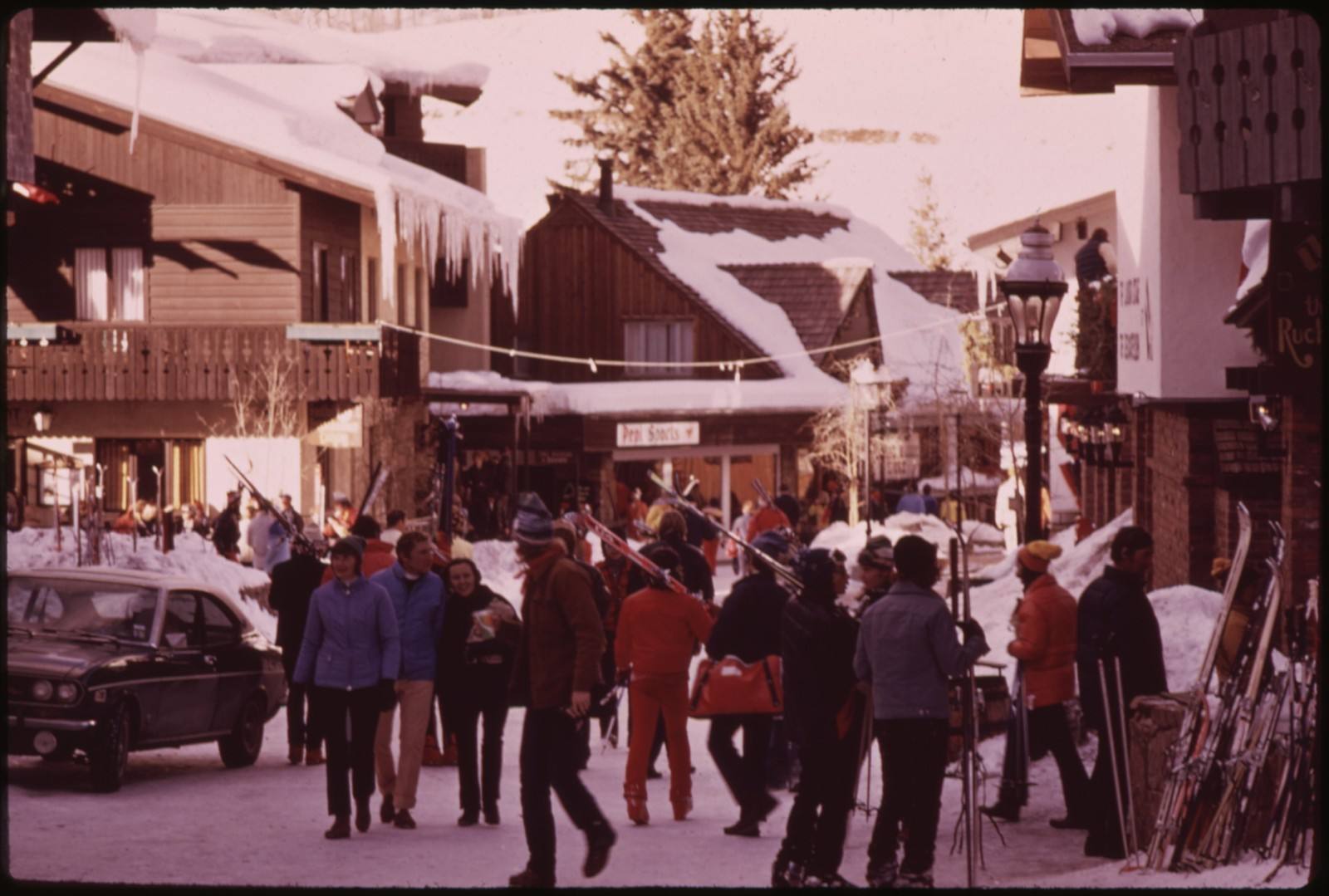 Skiers crowd a snowy street in Vail village in the 1970s, the festival's host town.
