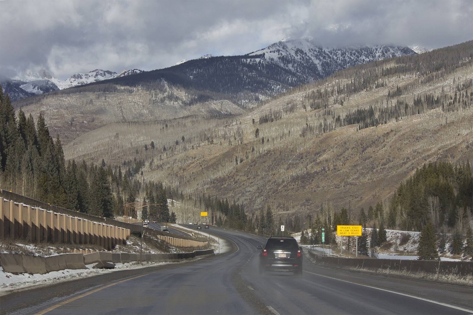 Interstate 70 climbs toward Vail Pass below the snow-capped Gore Range in a file photograph, near milepost 183. Under the traction law, this stretch between Dotsero and Morrison carries tire and chain requirements from Sept. 1 through May 31.