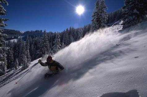 A skier carves through powder in Blue Sky Basin at Vail. Pass product unit sales through Sept. 18 were down 12 percent from the prior-year period.